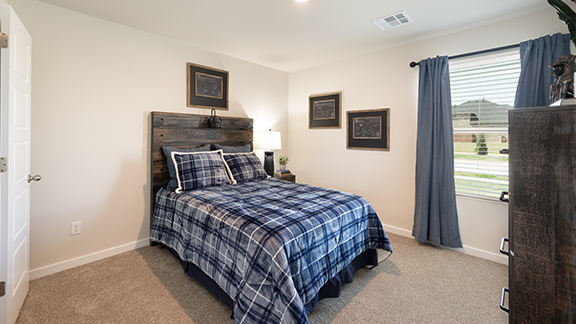 Second guest bedroom with carpet and windows