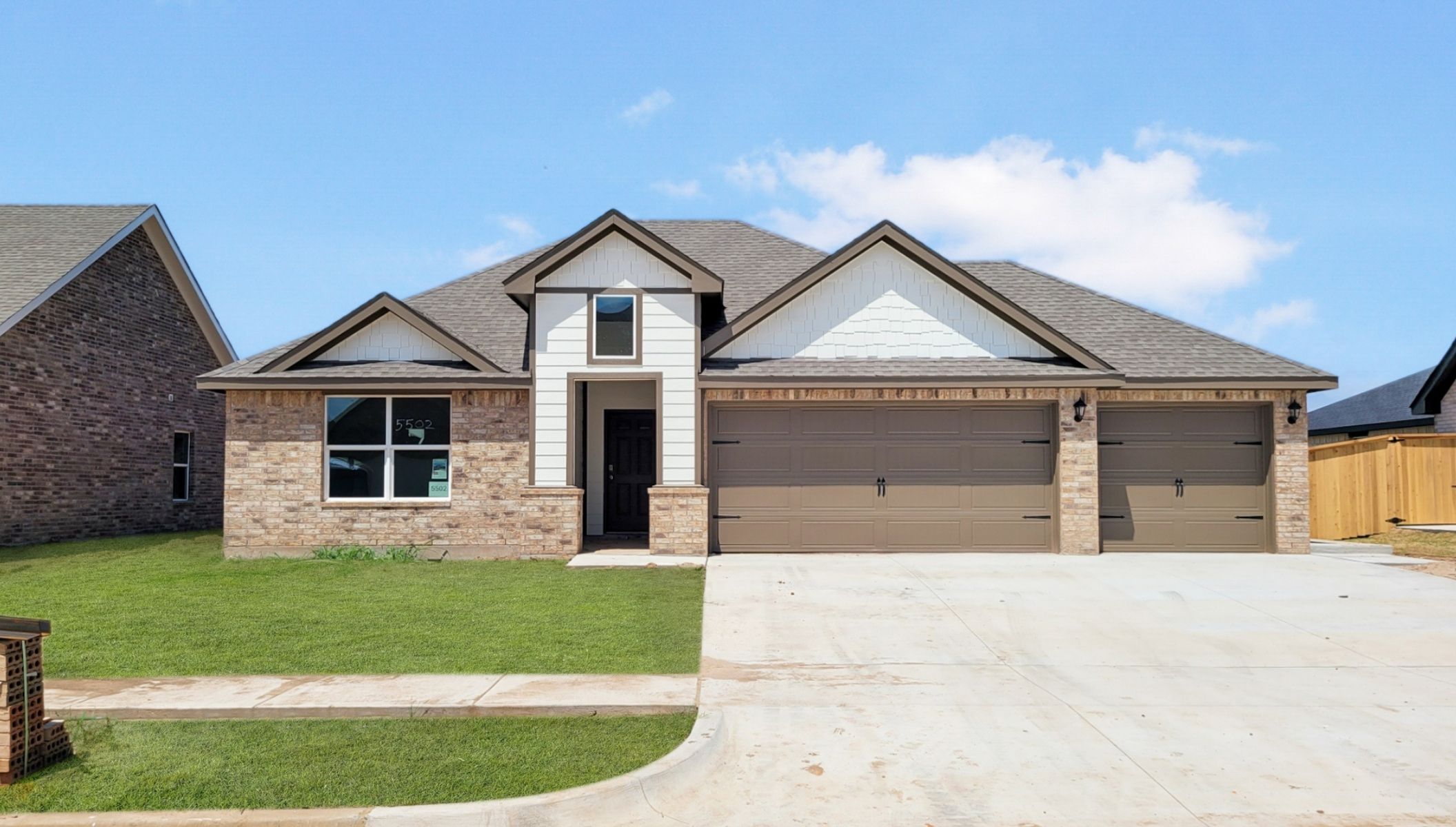 Single-story home rendering with two-car garage.