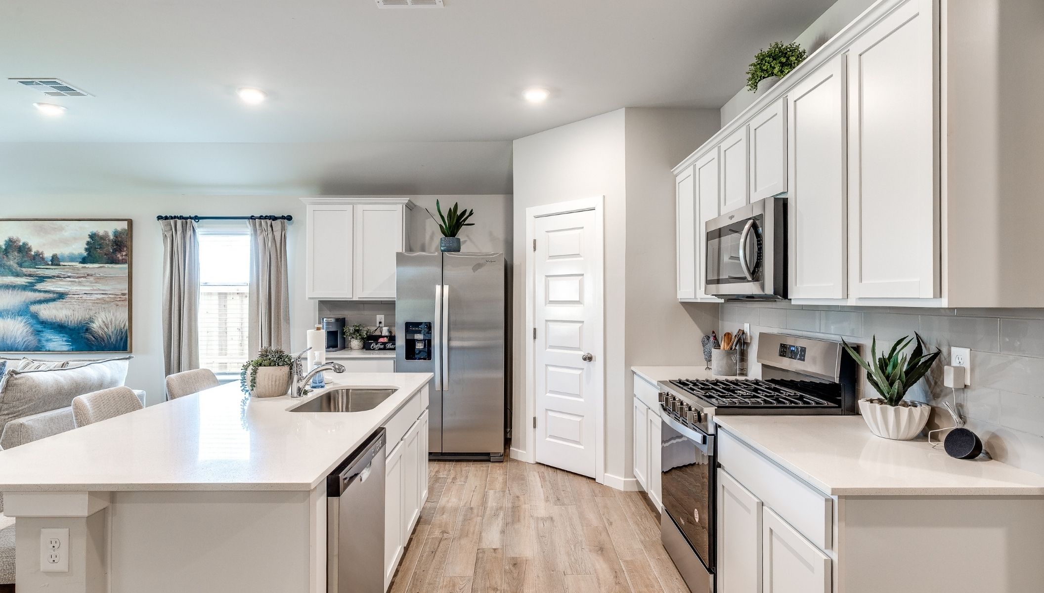 spacious kitchen with corner pantry, kitchen island and painted cabinets