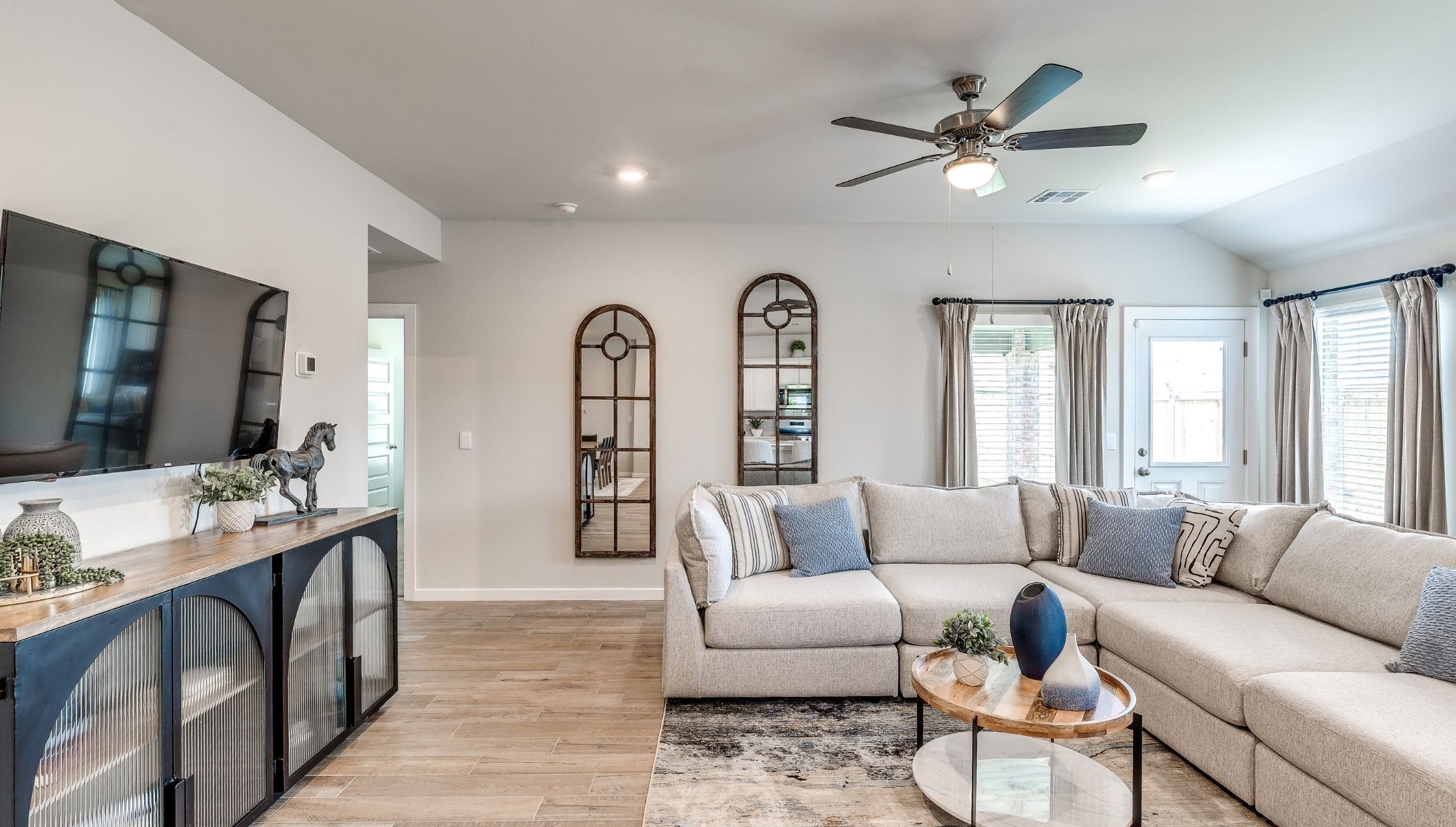 living area with fan and windows