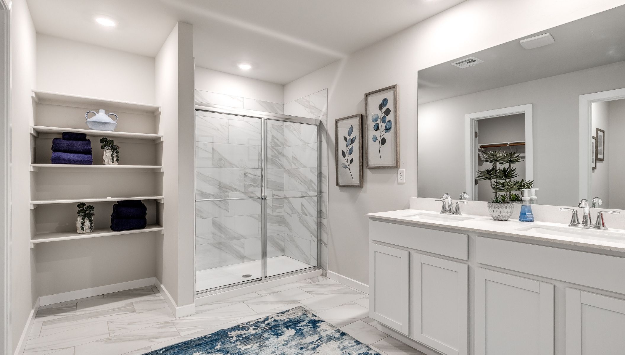 primary bathroom with shower and double vanity