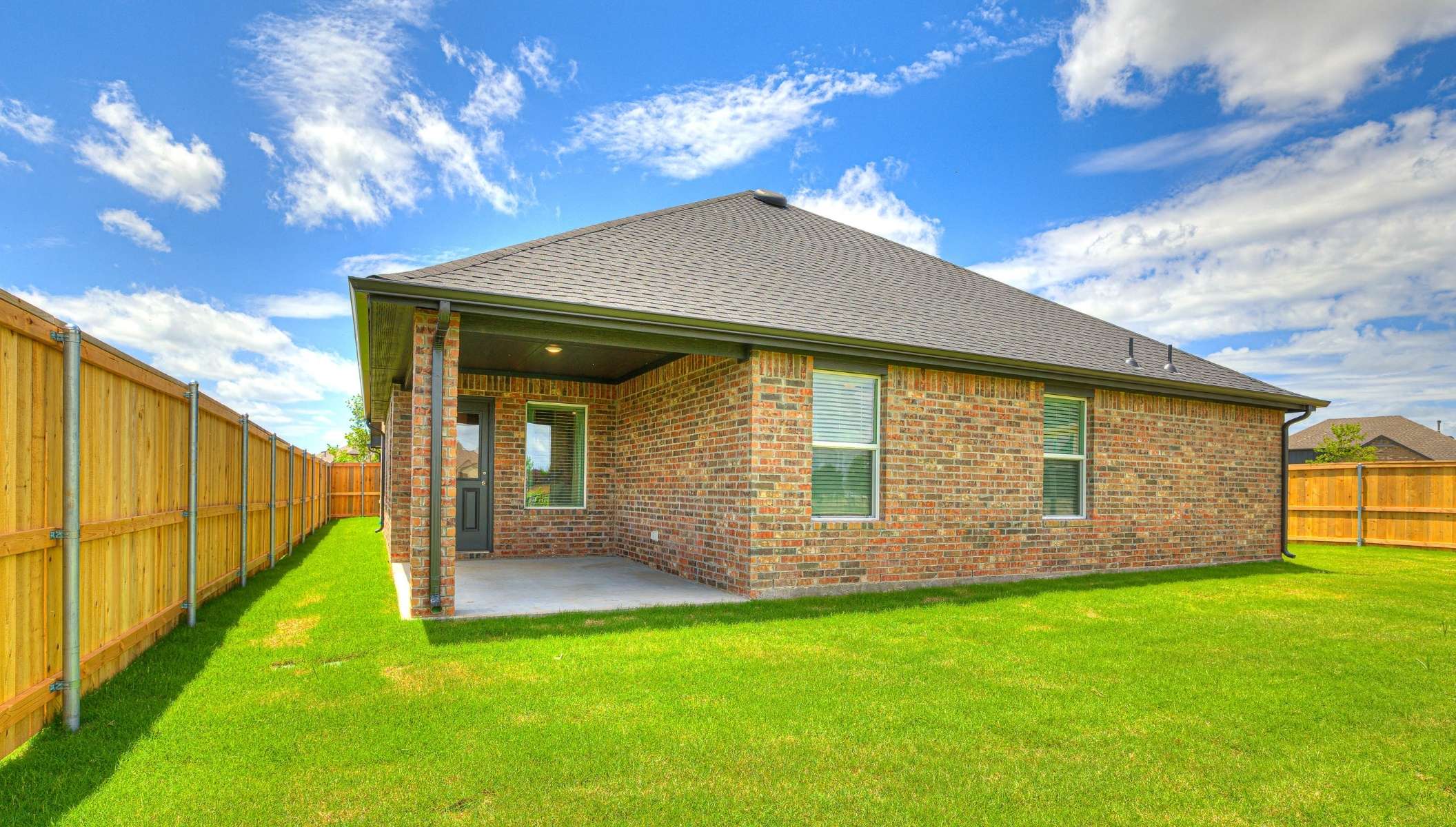 single story back exterior with covered patio