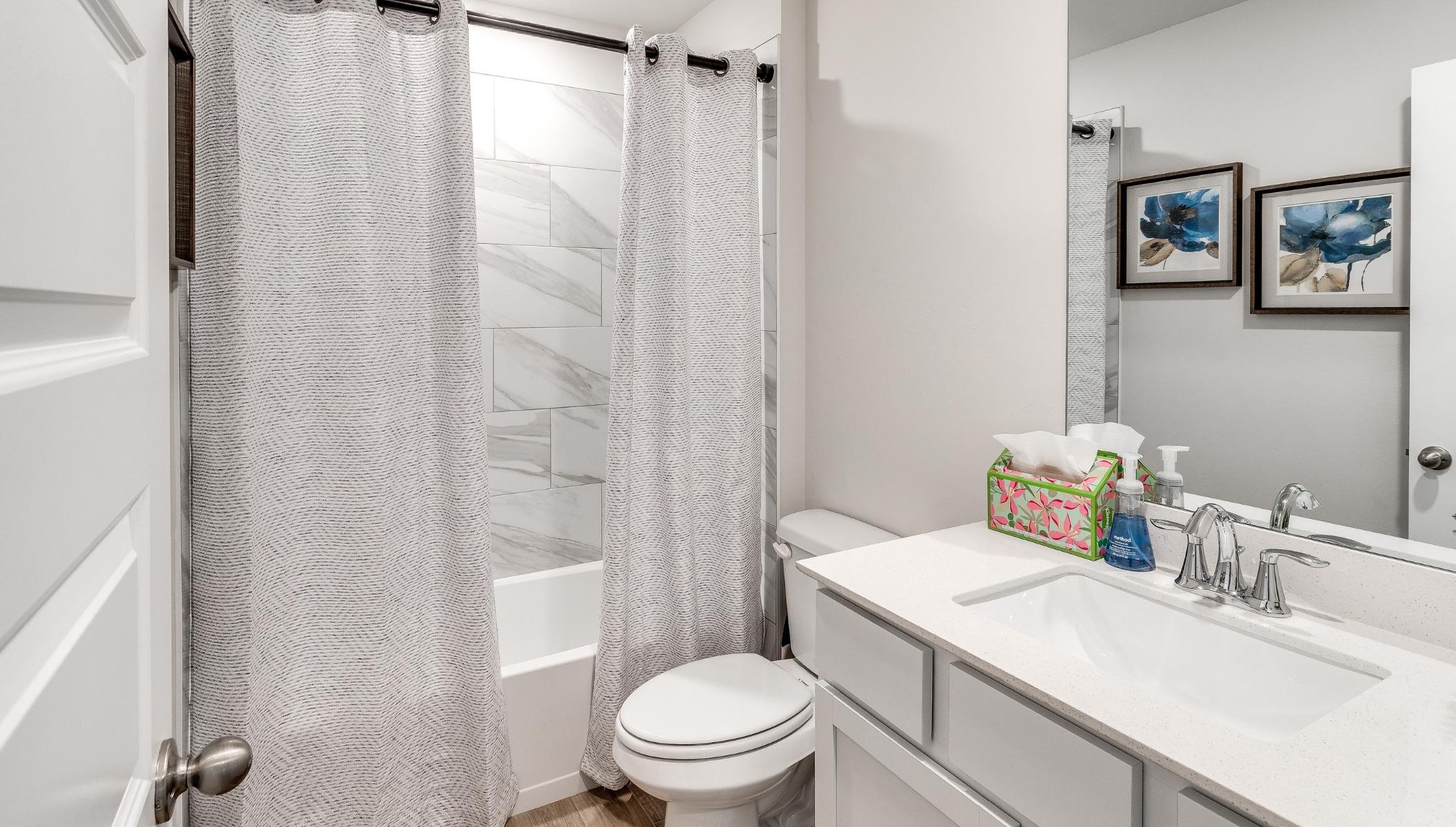 secondary bathroom with vanity and shower
