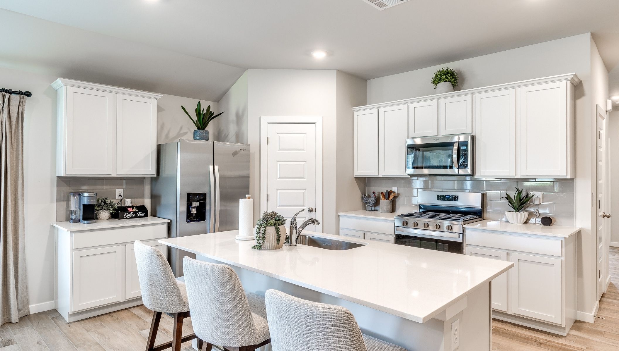 spacious kitchen with corner pantry, kitchen island and painted cabinets