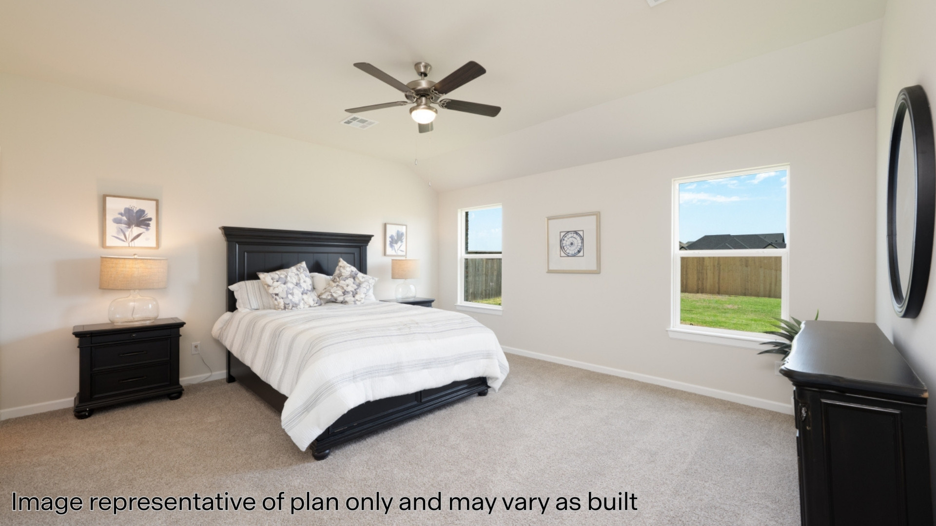 Primary bedroom with carpet and windows