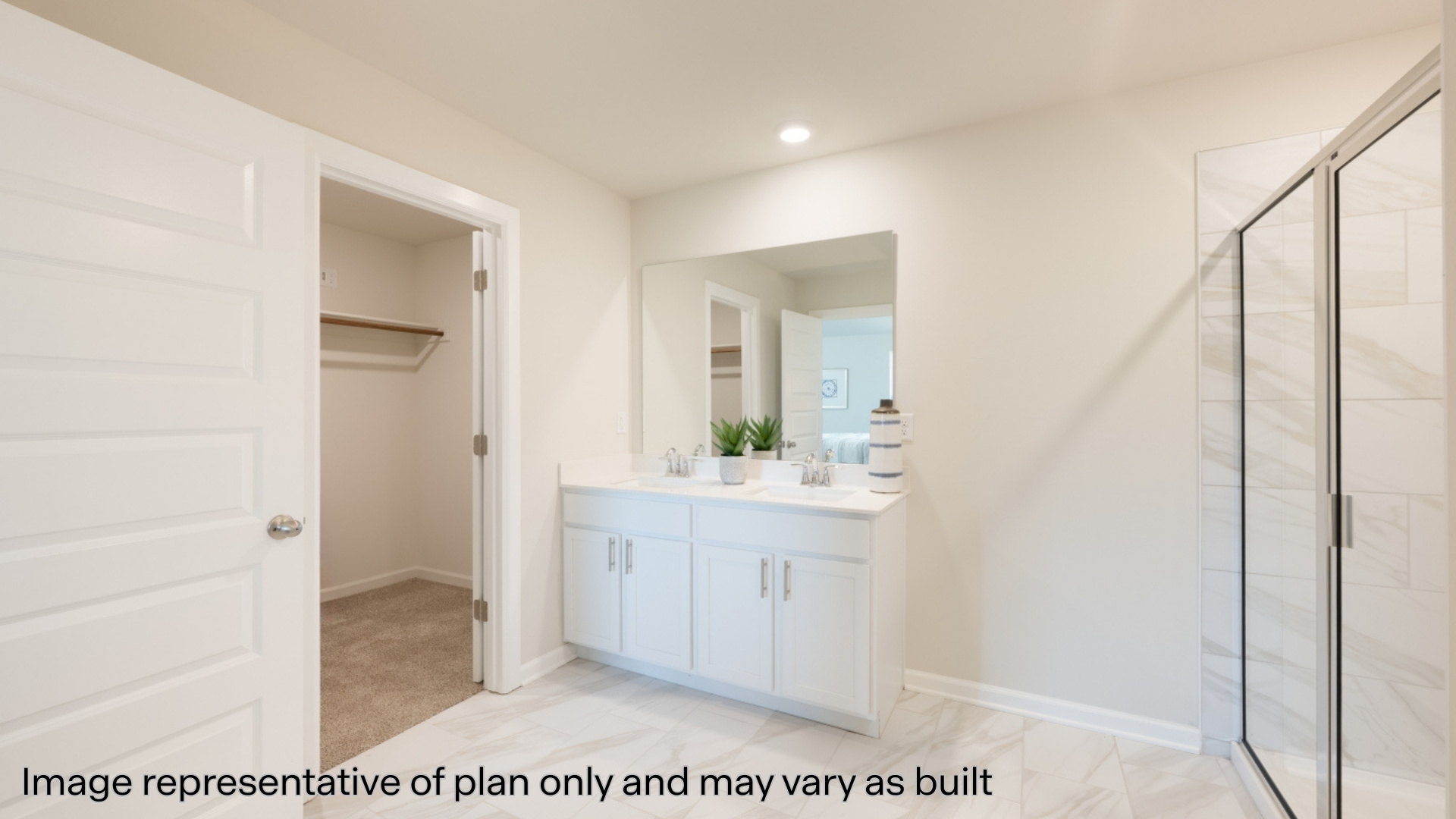 Primary bathroom with tile flooring and dual sinks
