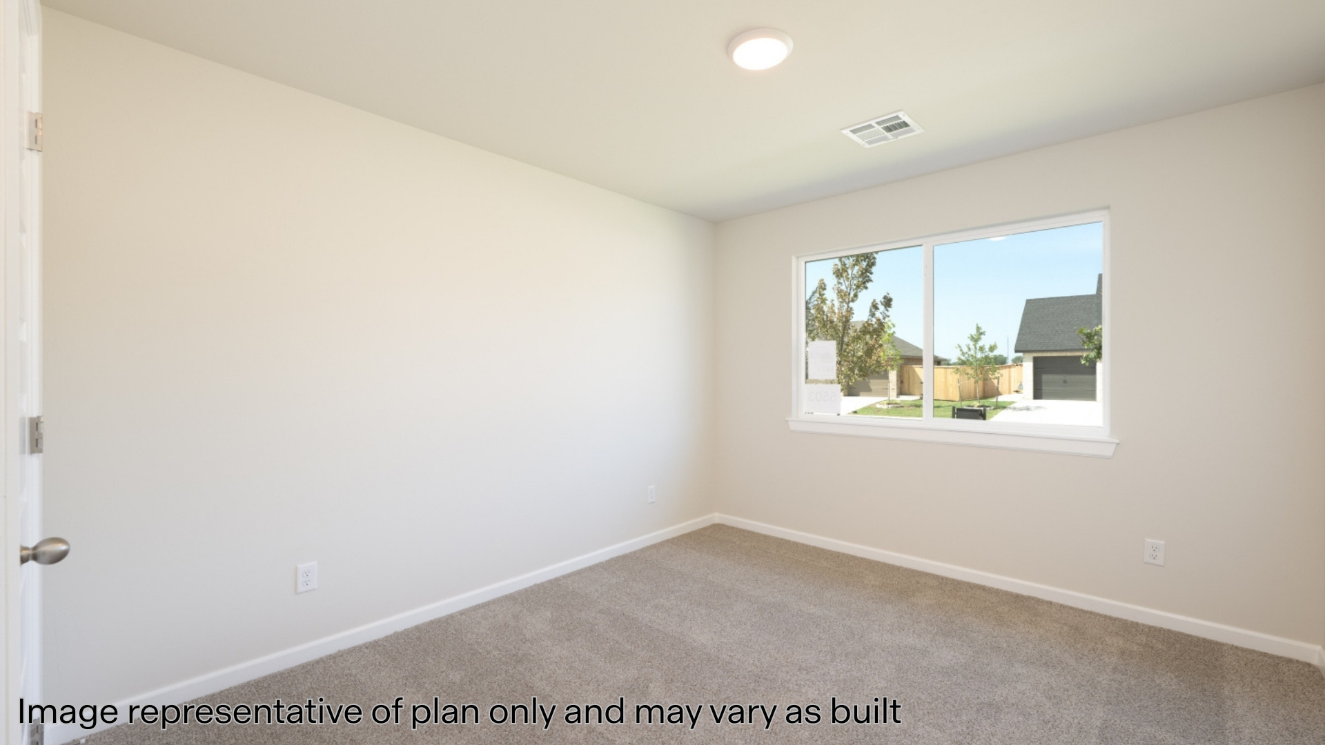 Secondary bedroom with carpet and windows
