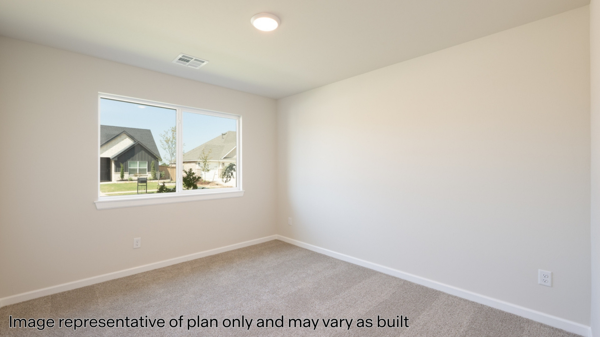 Secondary bedroom with carpet and windows