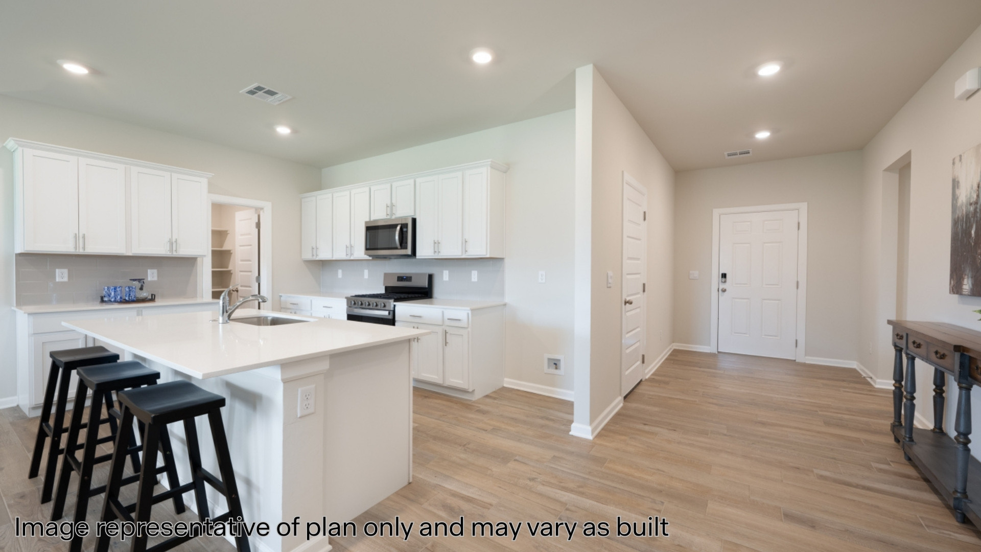 Kitchen with stainless steel appliances and quartz countertops