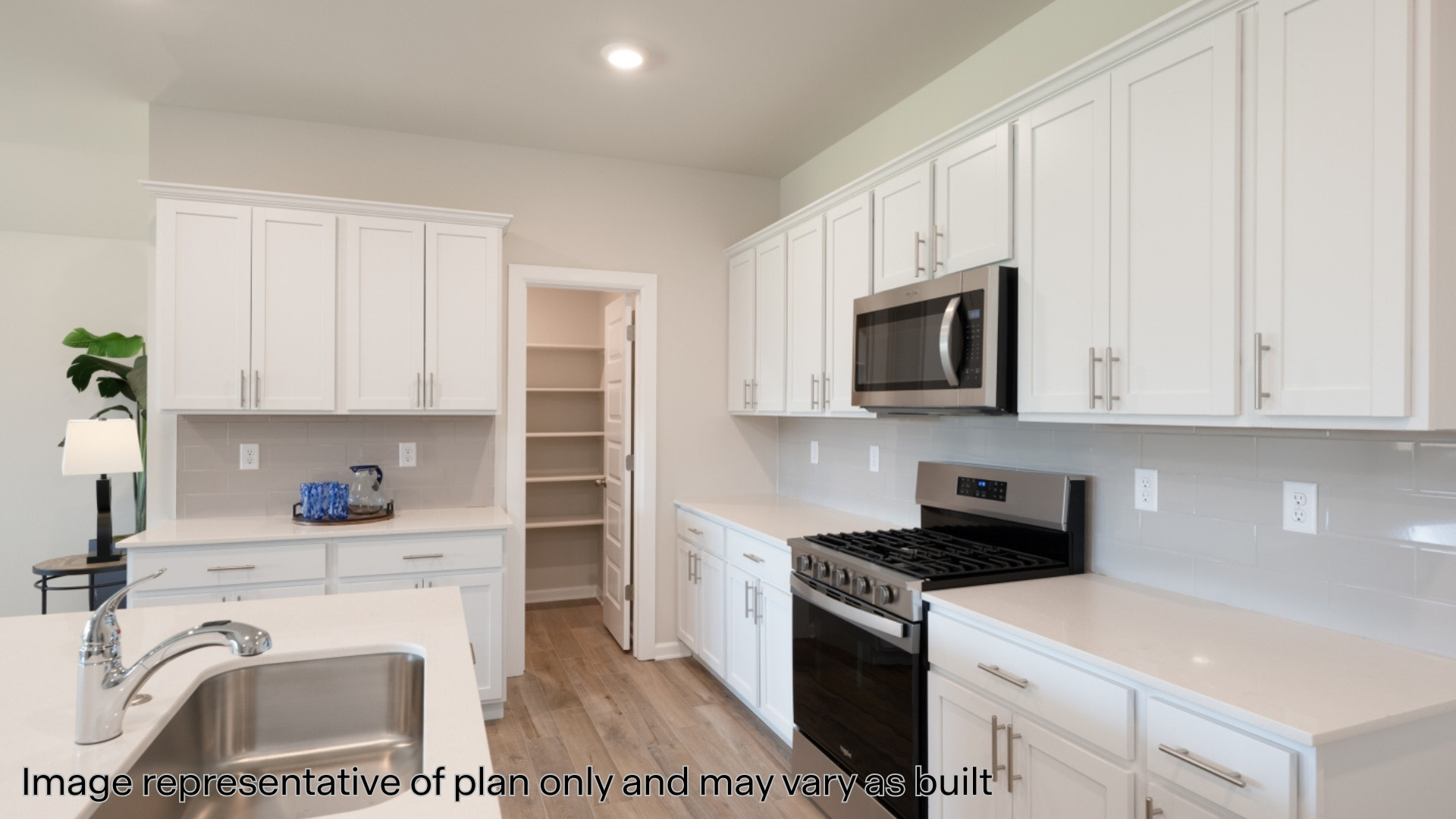 Kitchen with stainless steel appliances and quartz countertops