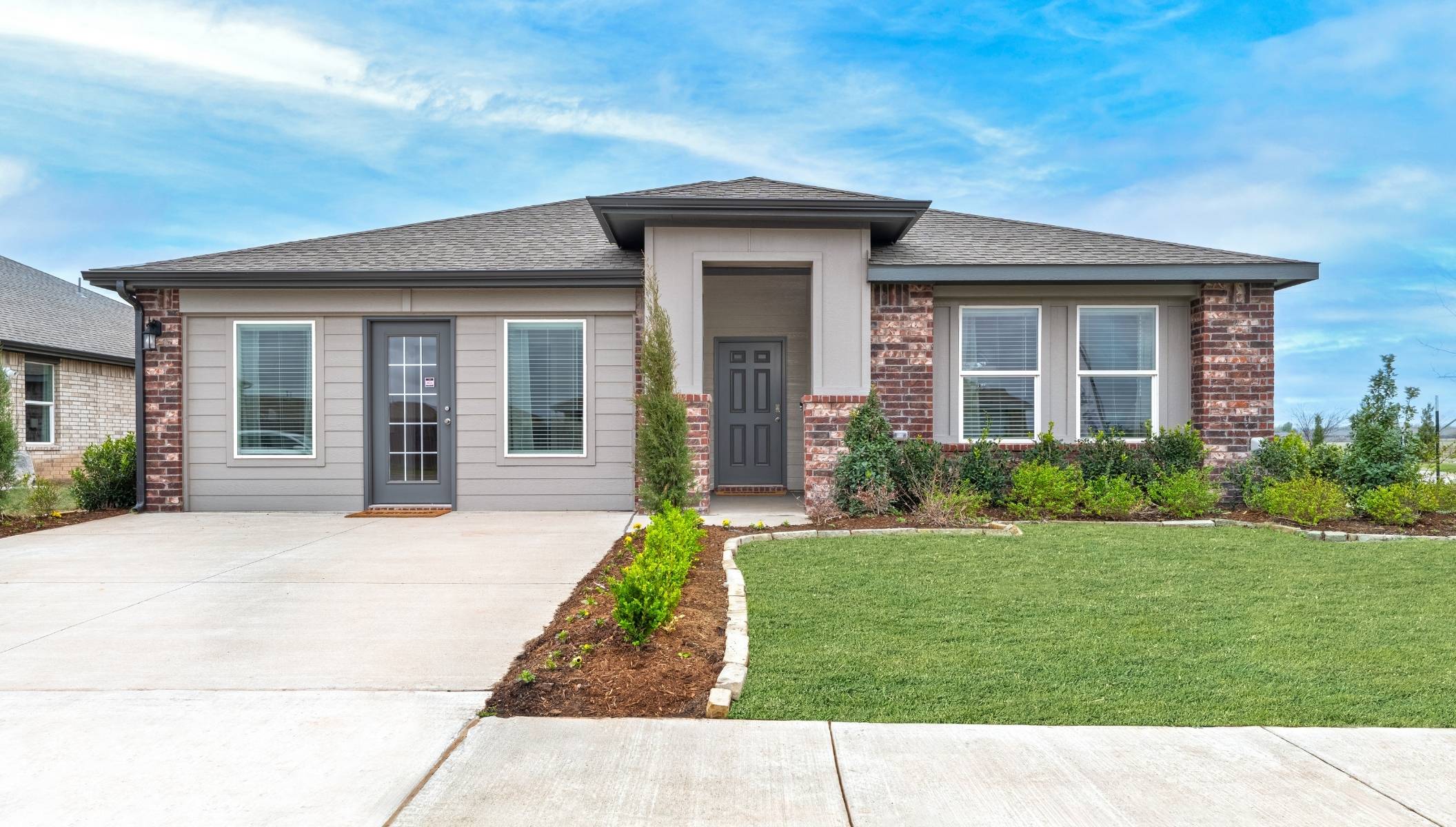 Single-story home rendering with two-car garage.
