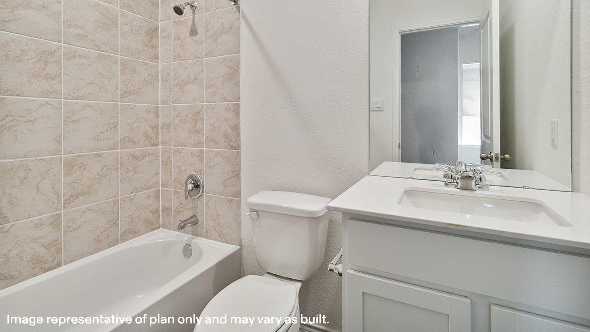 Full bathroom with shower / washtub combination, vanity, and a textured wall