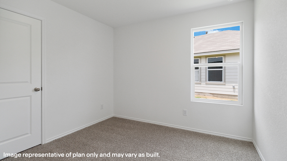 Carpeted spare room featuring baseboards