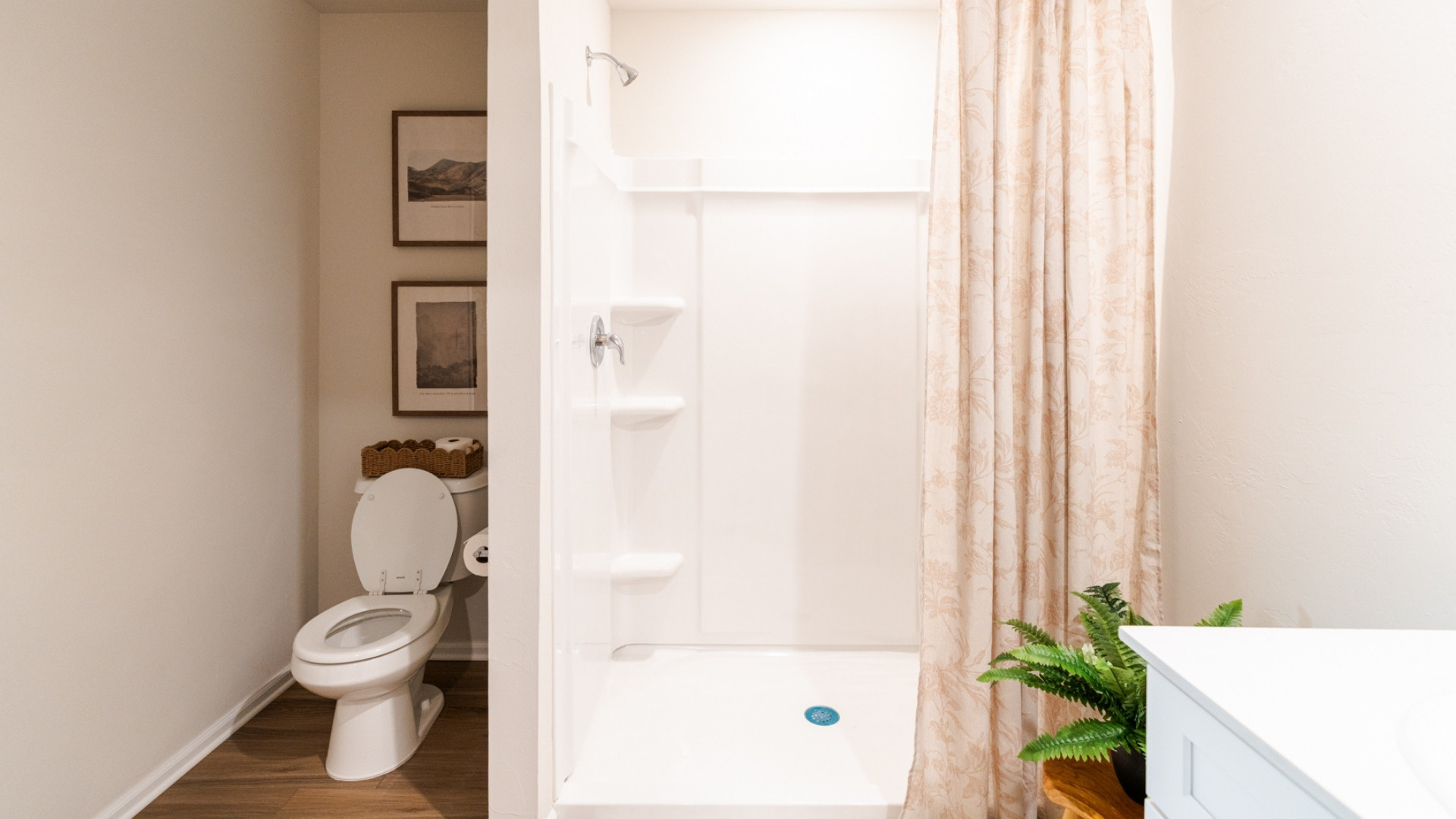 Bathroom with vanity, a shower stall, and wood finished floors