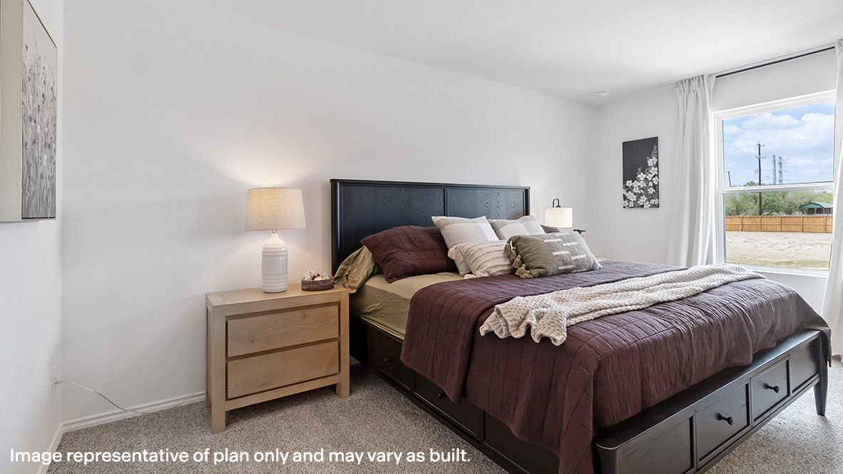 Carpeted bedroom featuring baseboards