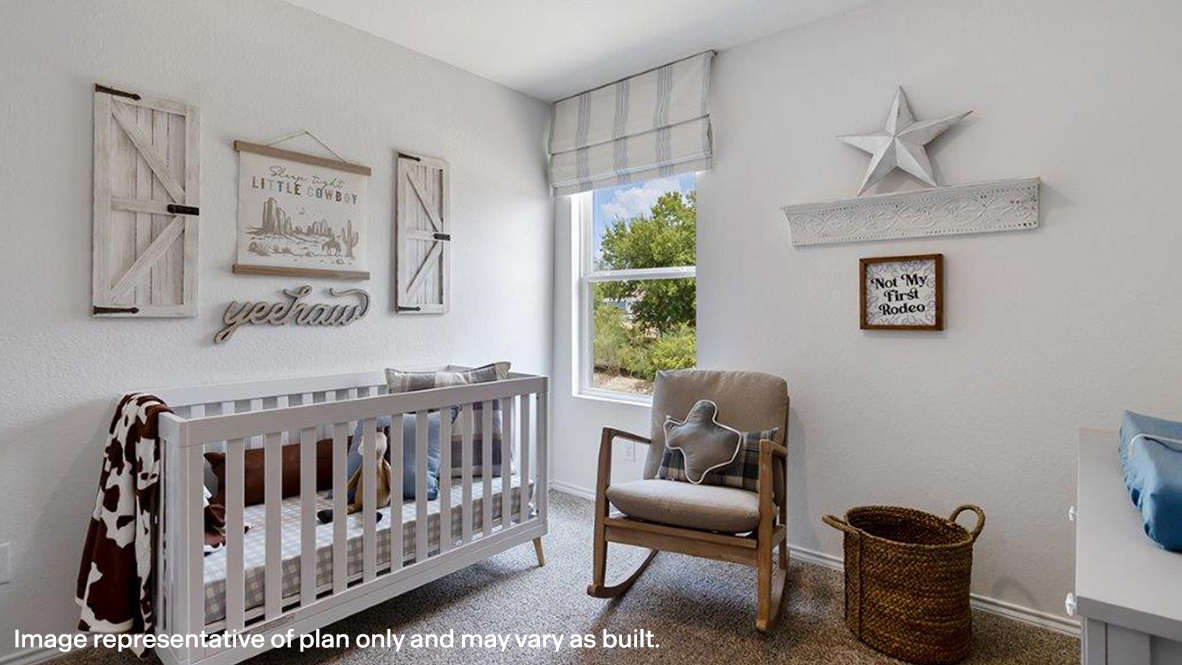 Carpeted bedroom with a nursery area and baseboards