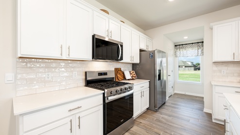 Kitchen with quartz countertops and stainless steel appliances