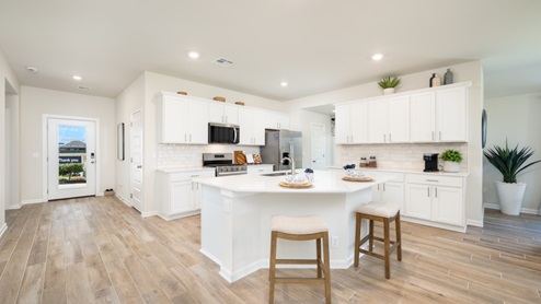Kitchen with quartz countertops and stainless steel appliances