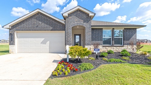 Front exterior of model home. Dark brick