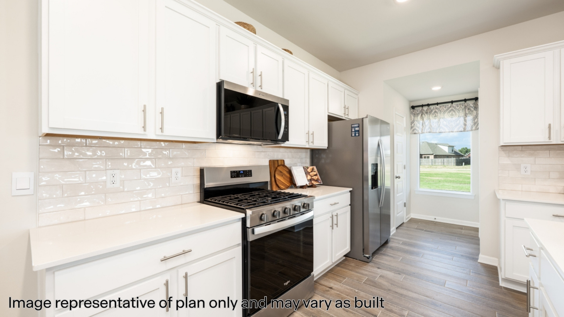 Kitchen featuring backsplash, appliances with stainless steel finishes, white cabinetry, and recessed lighting
