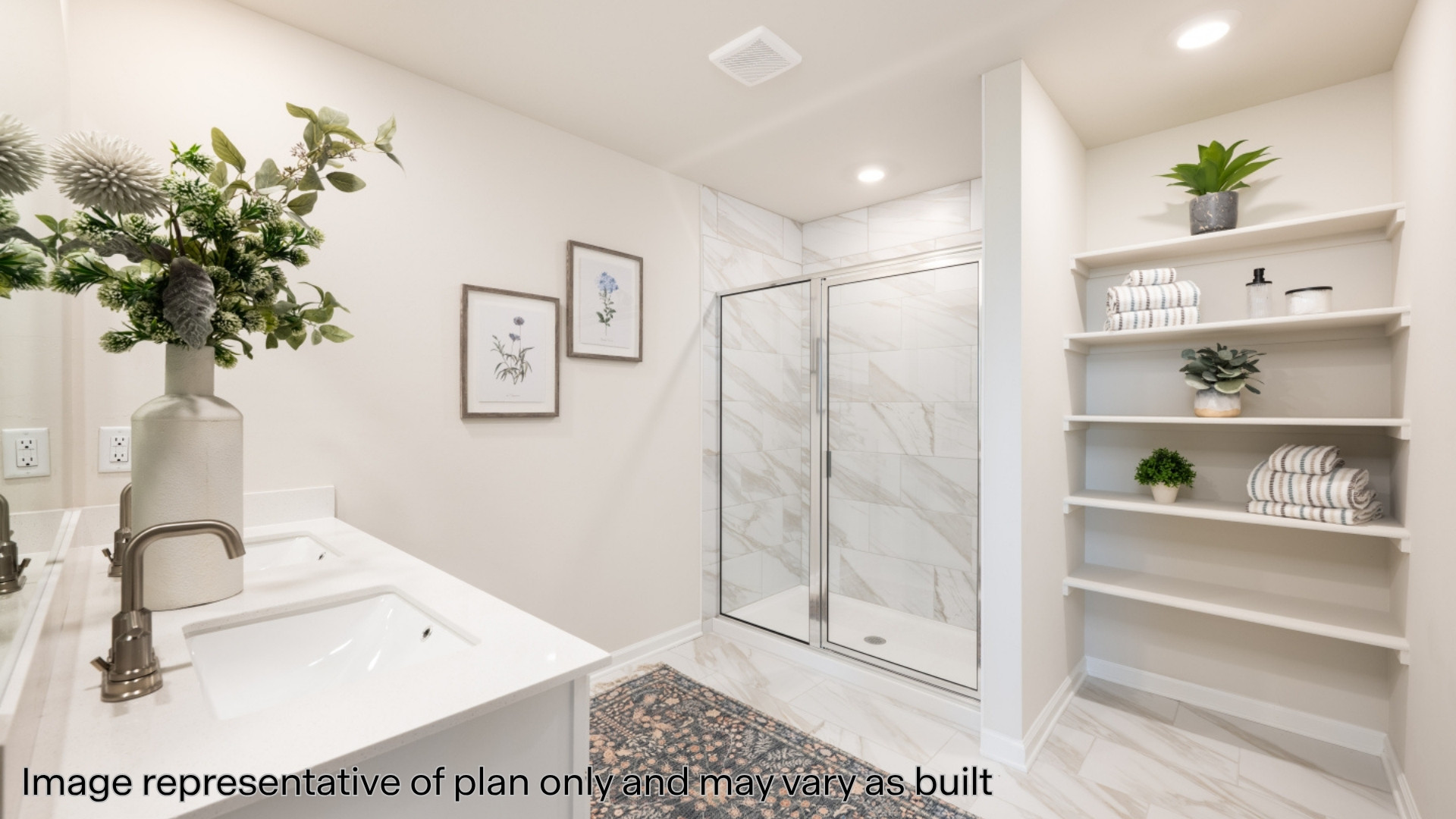 Ensuite bathroom featuring double vanity, a shower stall, light carpet, and recessed lighting