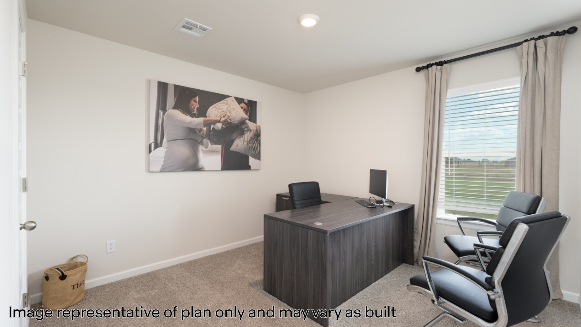 Office with light colored carpet and recessed lighting
