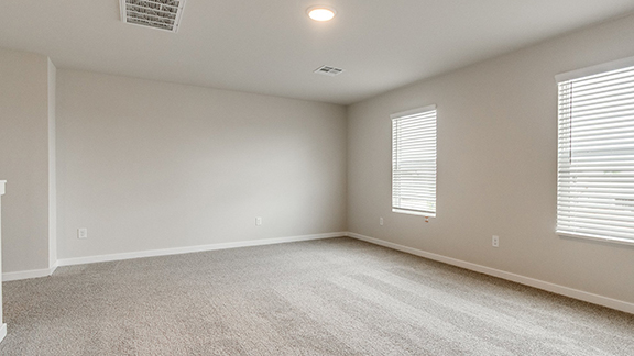 Empty room with light carpet and baseboards