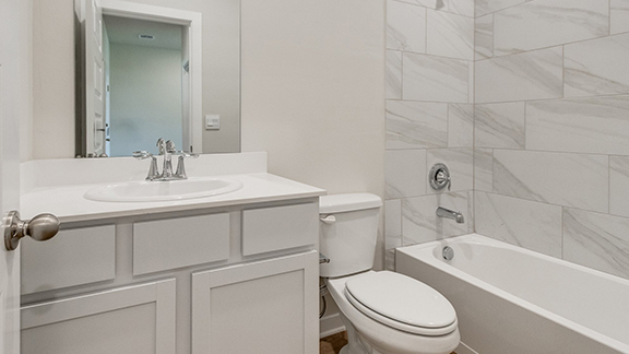 Full bath featuring vanity and bathing tub / shower combination
