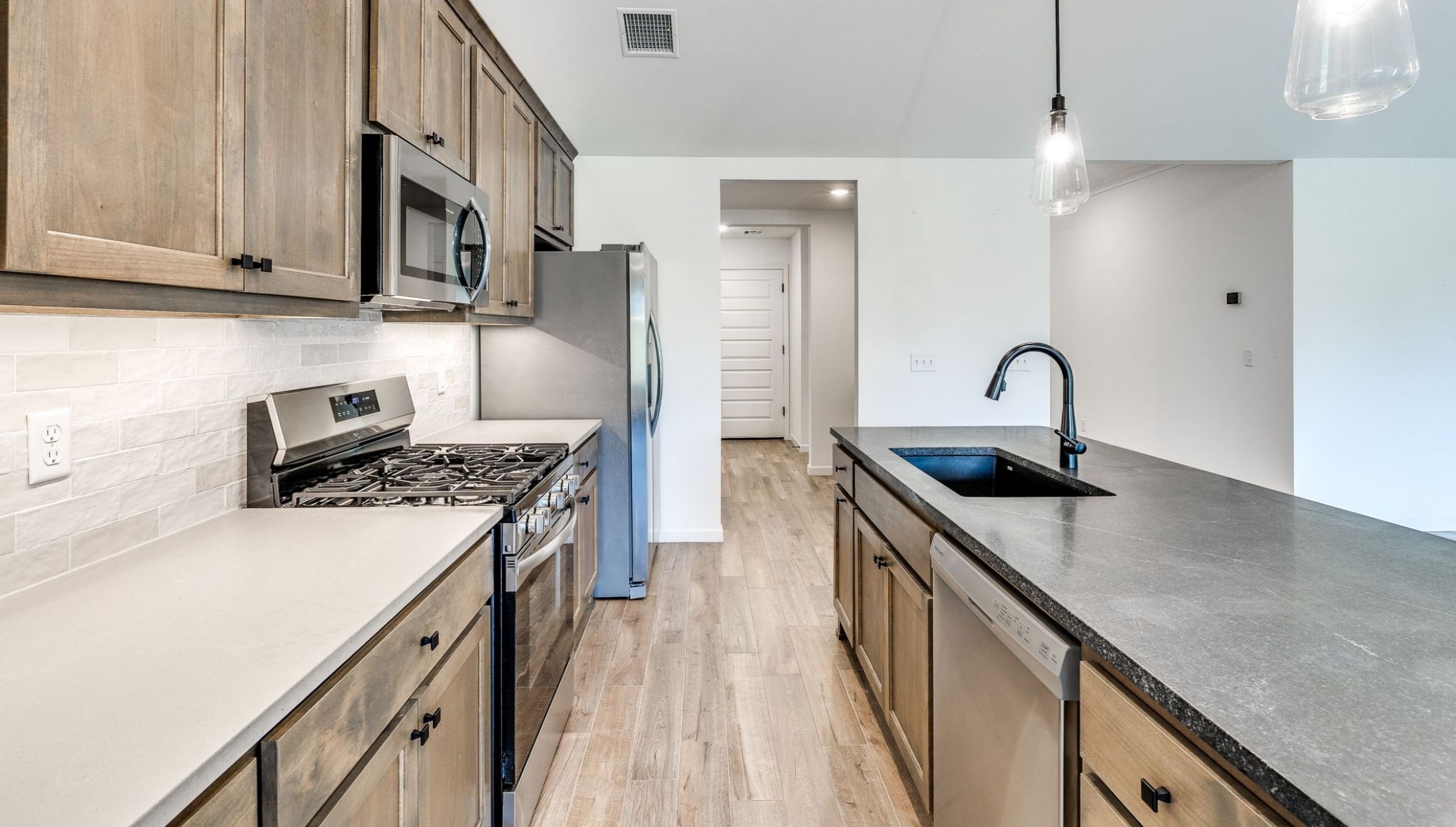 kitchen island with lights and stained cabinets