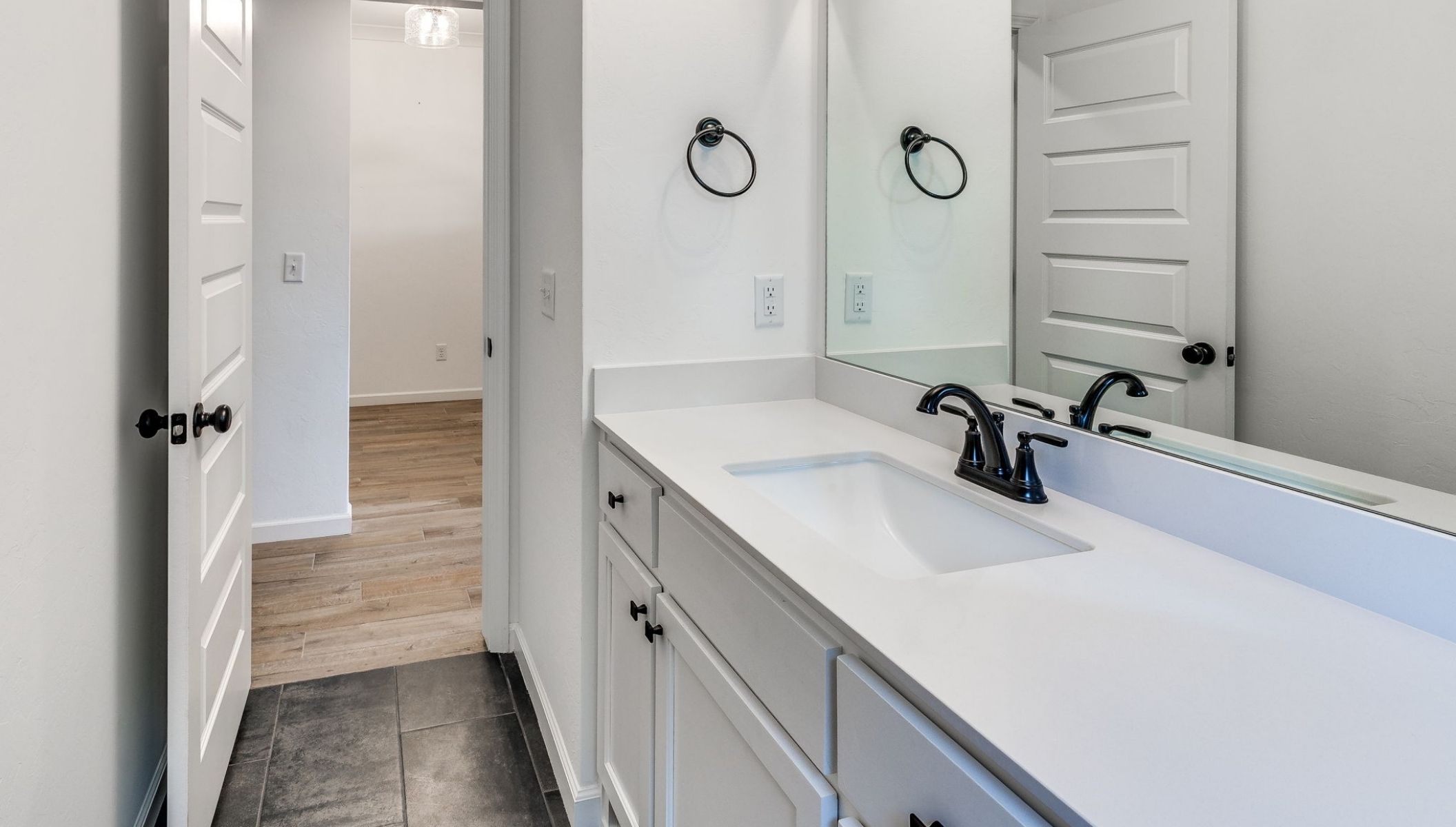 secondary bathroom with vanity and shower