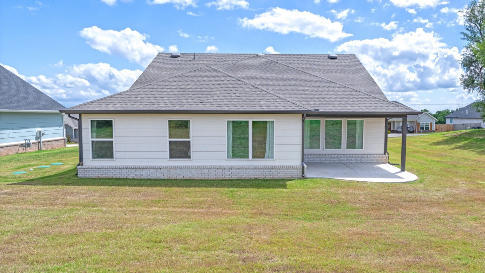 Full back exterior of home with yard.