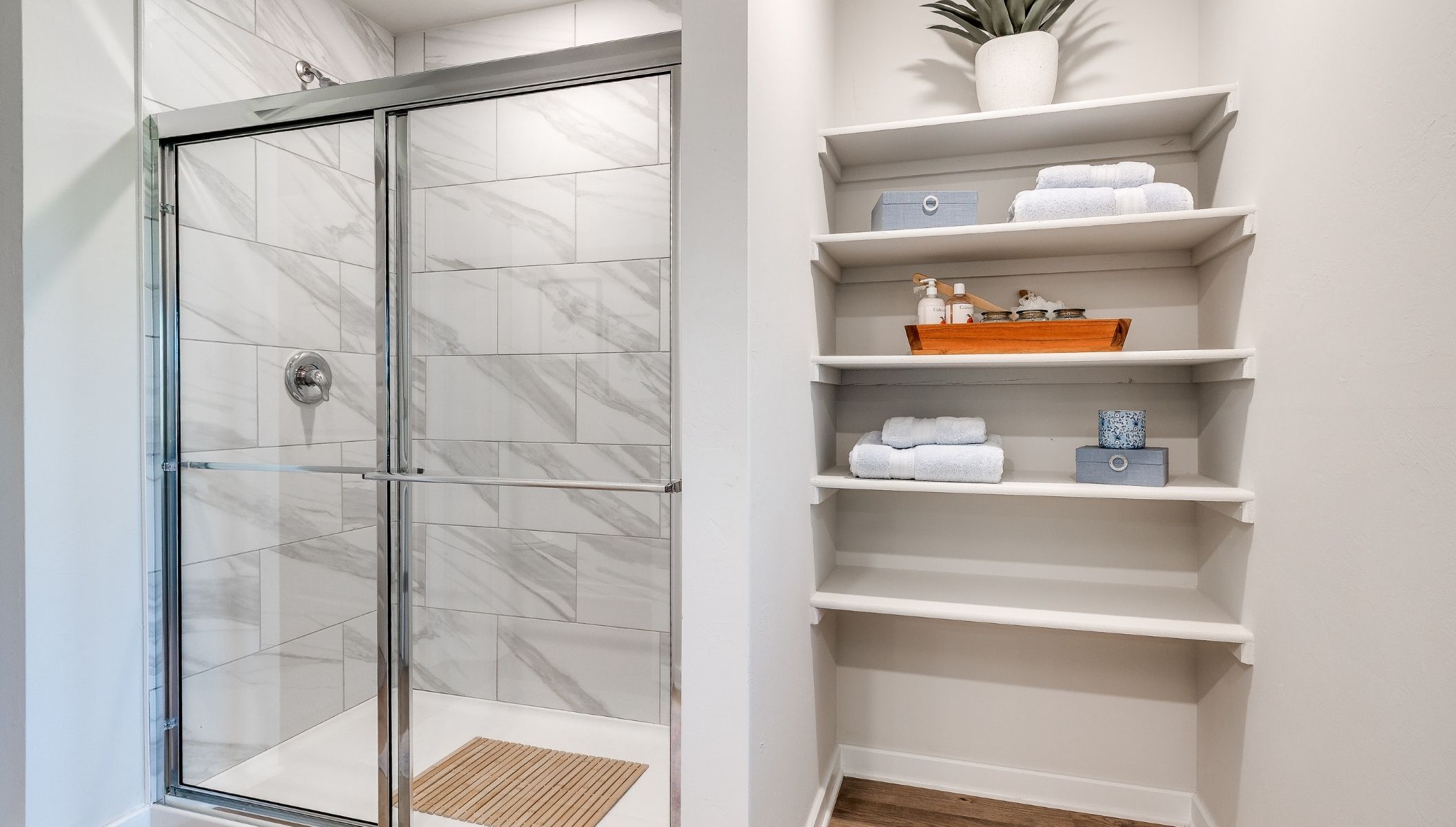 primary bathroom with shower and shelf