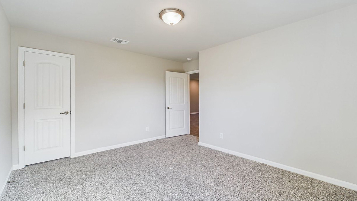 The single story Lakeview home plan bedroom has lots of natural light.