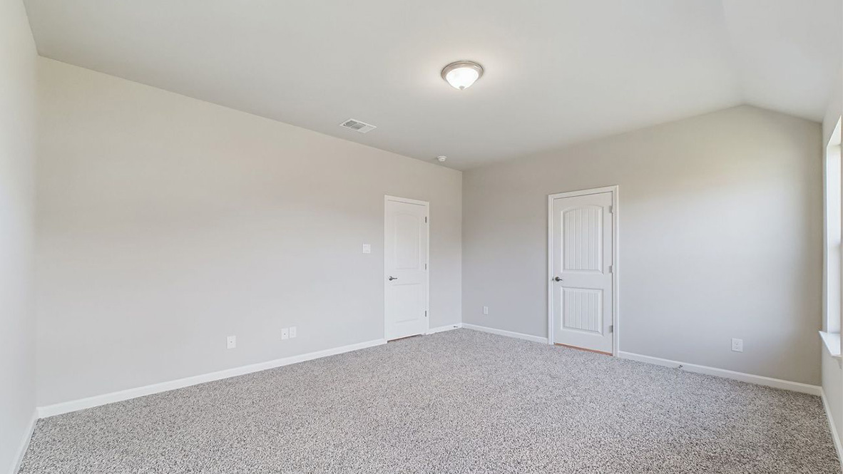 The single story Lakeview home plan bedroom has lots of natural light.