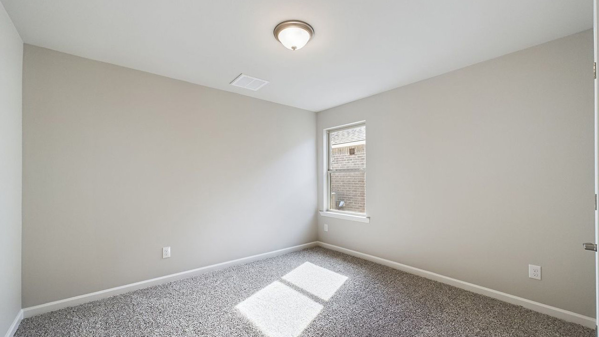 The single story Lakeview home plan bedroom has lots of natural light.