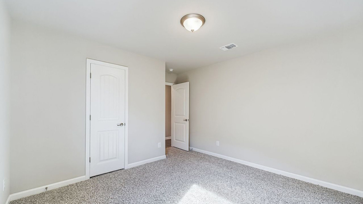 The single story Lakeview home plan bedroom has lots of natural light.