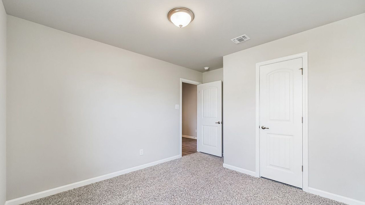 The single story Lakeview home plan bedroom has lots of natural light.