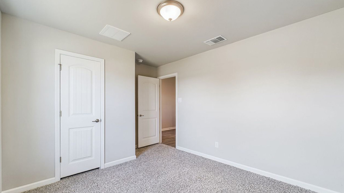The single story Lakeview home plan bedroom has lots of natural light.