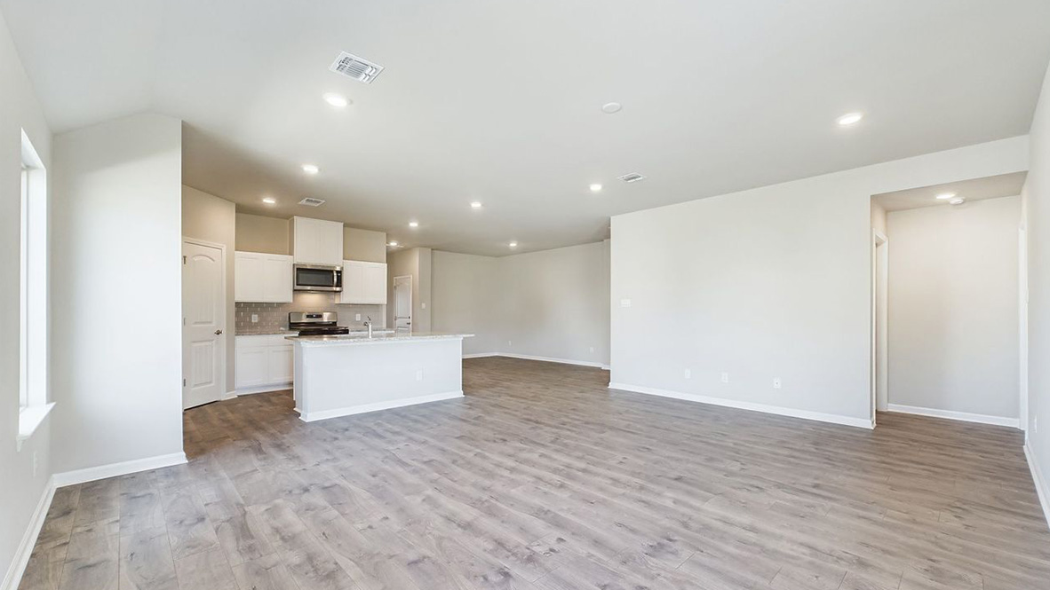 The single story Lakeview home plan has a spacious kitchen and island with granite countertops.