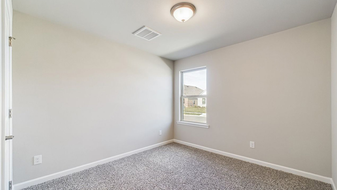 The single story Lakeview home plan bedroom has lots of natural light.