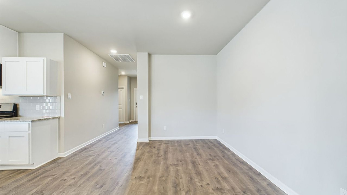 The single story Lakeview home plan has a spacious kitchen and island with granite countertops.