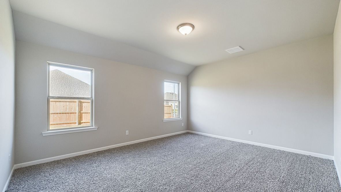 The single story Lakeview home plan bedroom has lots of natural light.