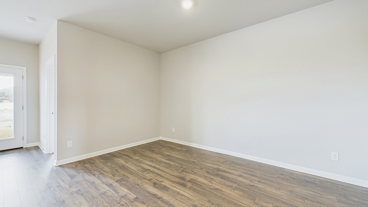 Kitchen, dining, family room combo in this new home includes modern design elements throughout