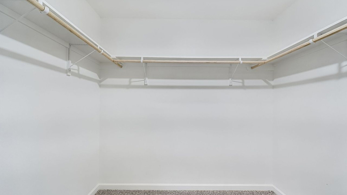 Spacious walk-in closet inside the primary bedroom next to ensuite, of D.R. Horton new construction home in Cedar Creek