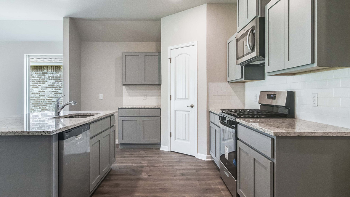 The Lakeview single-story new home rendering has a brick exterior and two car garage.