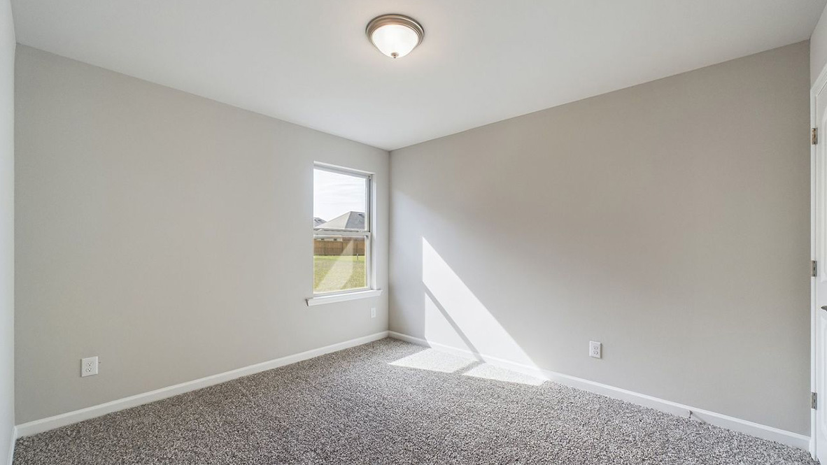 The Lakeview single-story new home rendering has a brick exterior and two car garage.