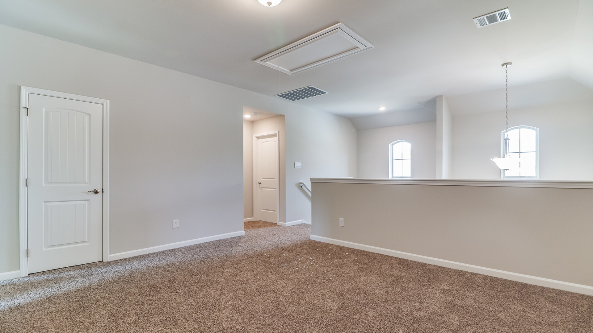 Open landing at the top of the stairs with carpet.