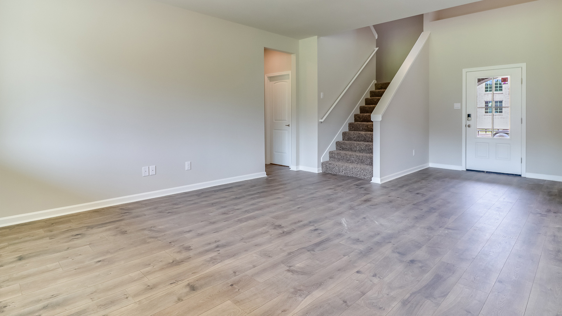 Main living area with clean flooring and natural light.
