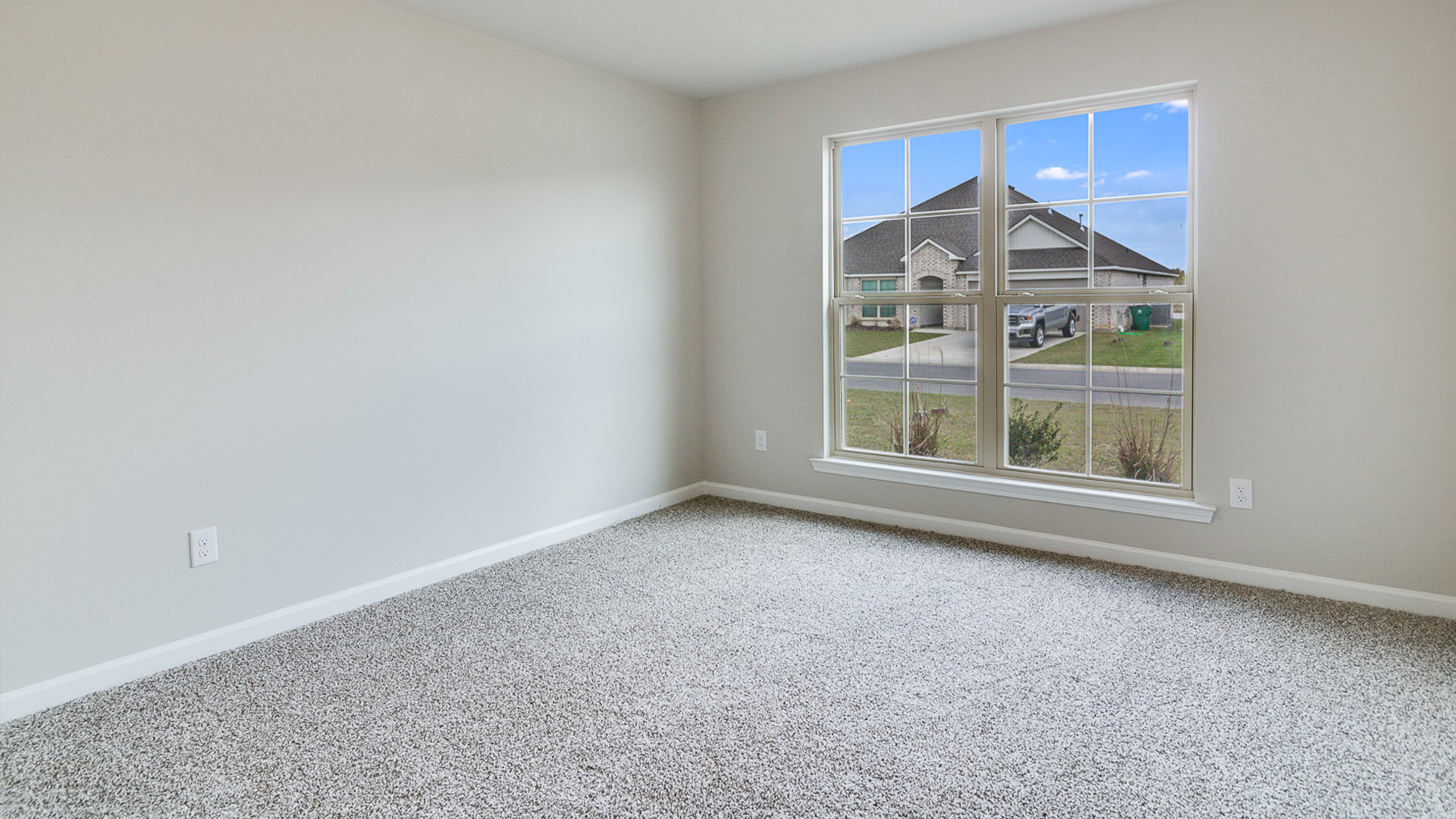 Primary bedroom features ample space, double windows, soft carpet, a stylish walk-in closet, and a private ensuite bath