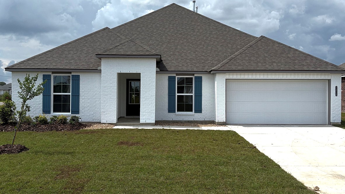 New home with brick accents and attached garage.